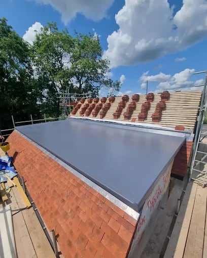 Large newly finished grey flat roof beside a pitched roof in Reading