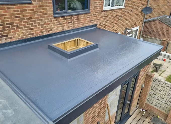 Smooth grey flat roof installation with a prepared rooflight opening on a Reading extension